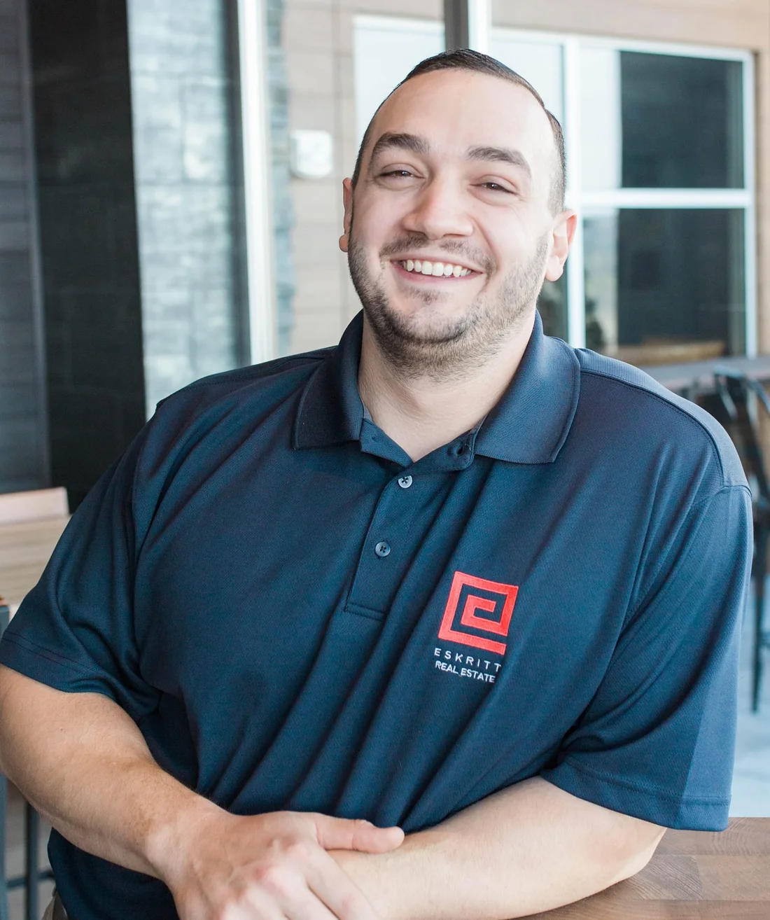 Greg Eskritt, smiling, in an Eskritt Real Estate Group polo